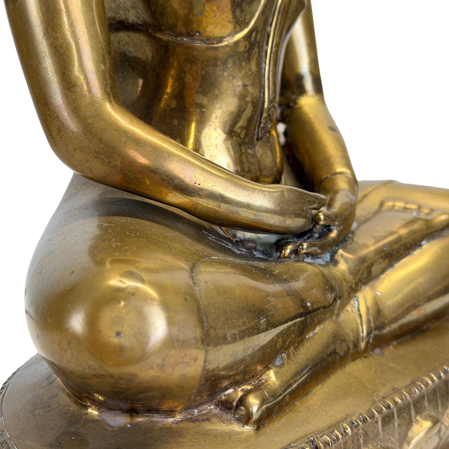 Hands of the antique Thai Shakyamuni Buddha resting in dhyana mudra