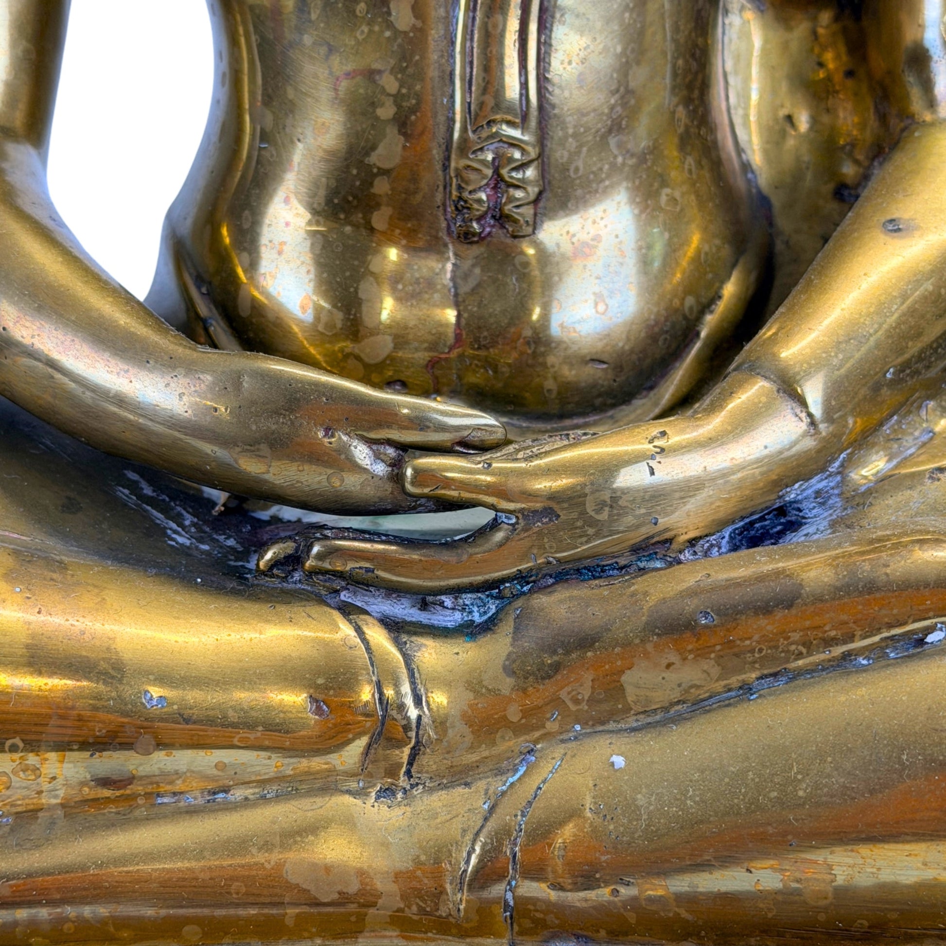 Hands and robe ornament detail on the 19th-century Thai Shakyamuni Buddha