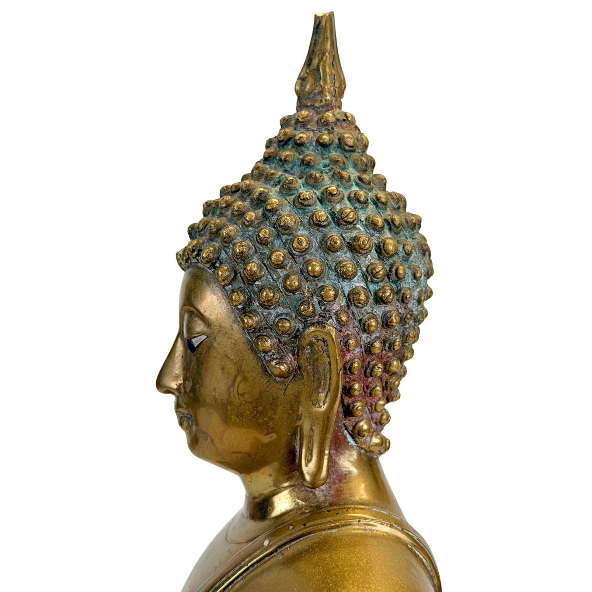 Left profile of the antique Thai Shakyamuni Buddha with aged patina