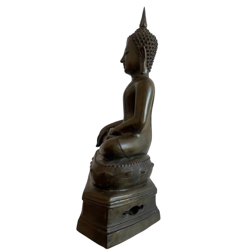 Left profile of the seated Thai Buddha on its lotus and tiered pedestal