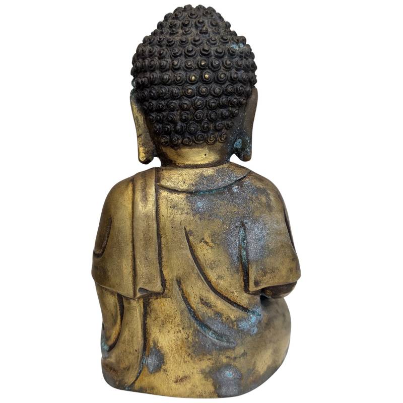 Blue-green patina and worn gilding on the Tibetan bronze Buddha