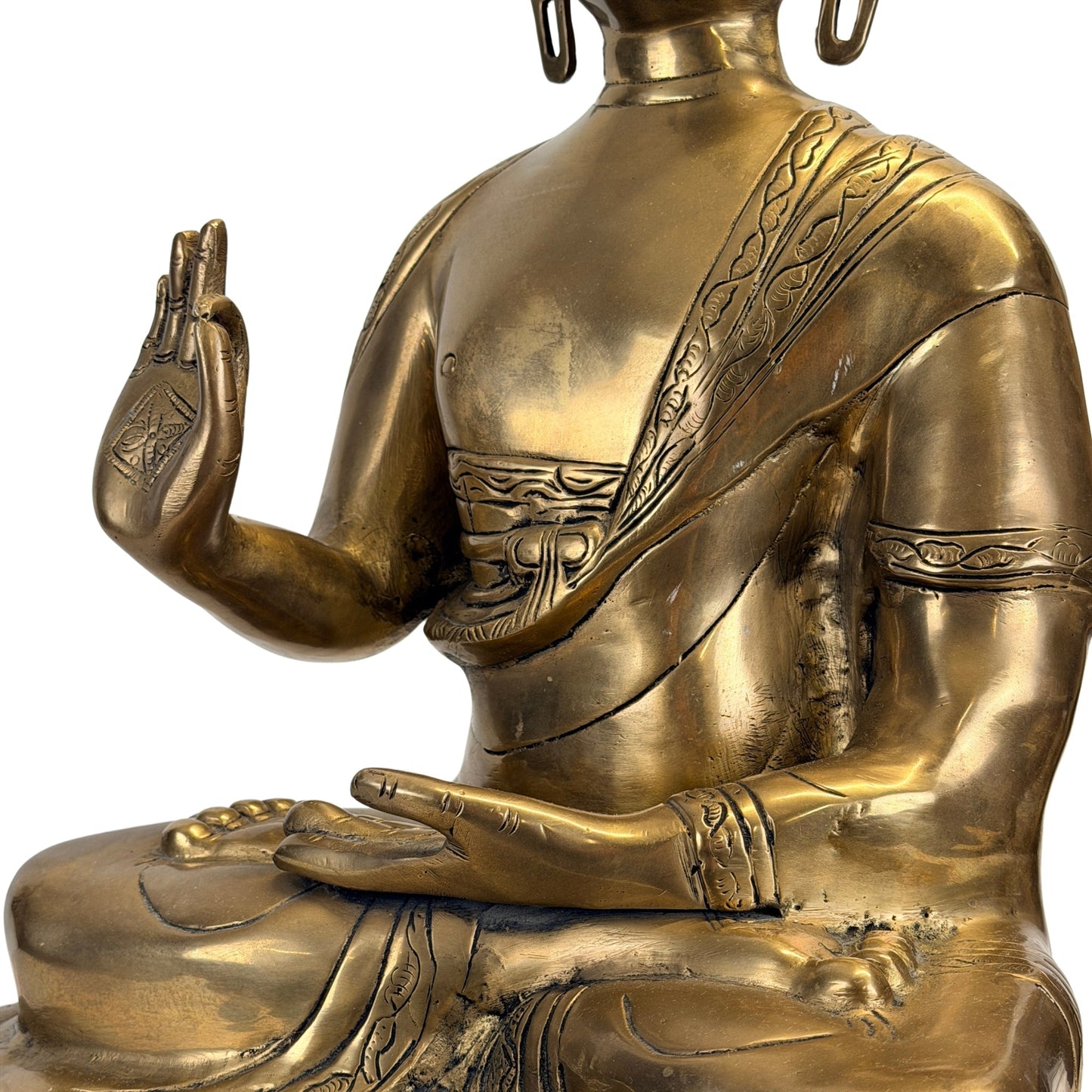 Hands, robe folds and aged patina of the antique Tibetan Shakyamuni Buddha