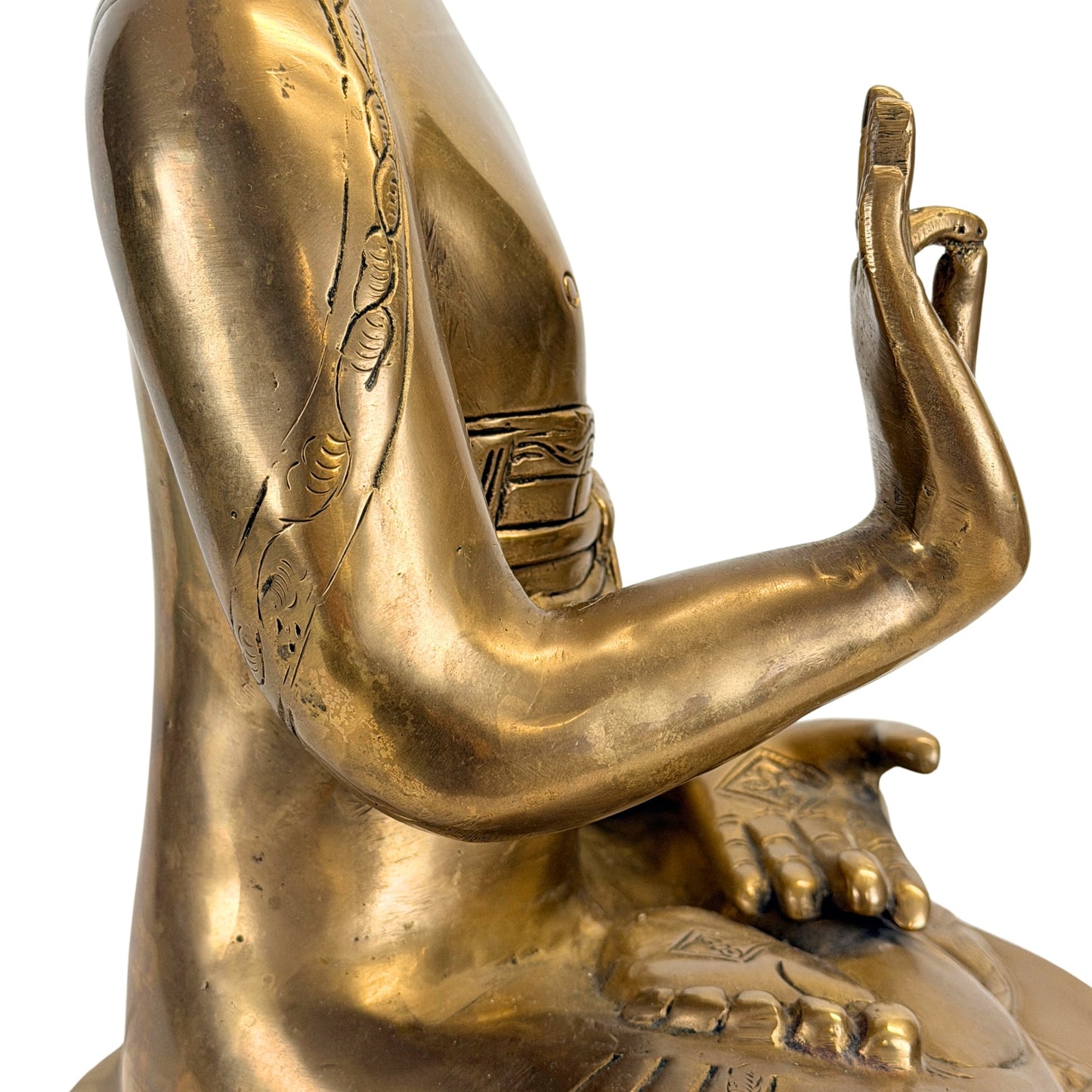Raised hand and arm detail of the antique Tibetan Shakyamuni Buddha