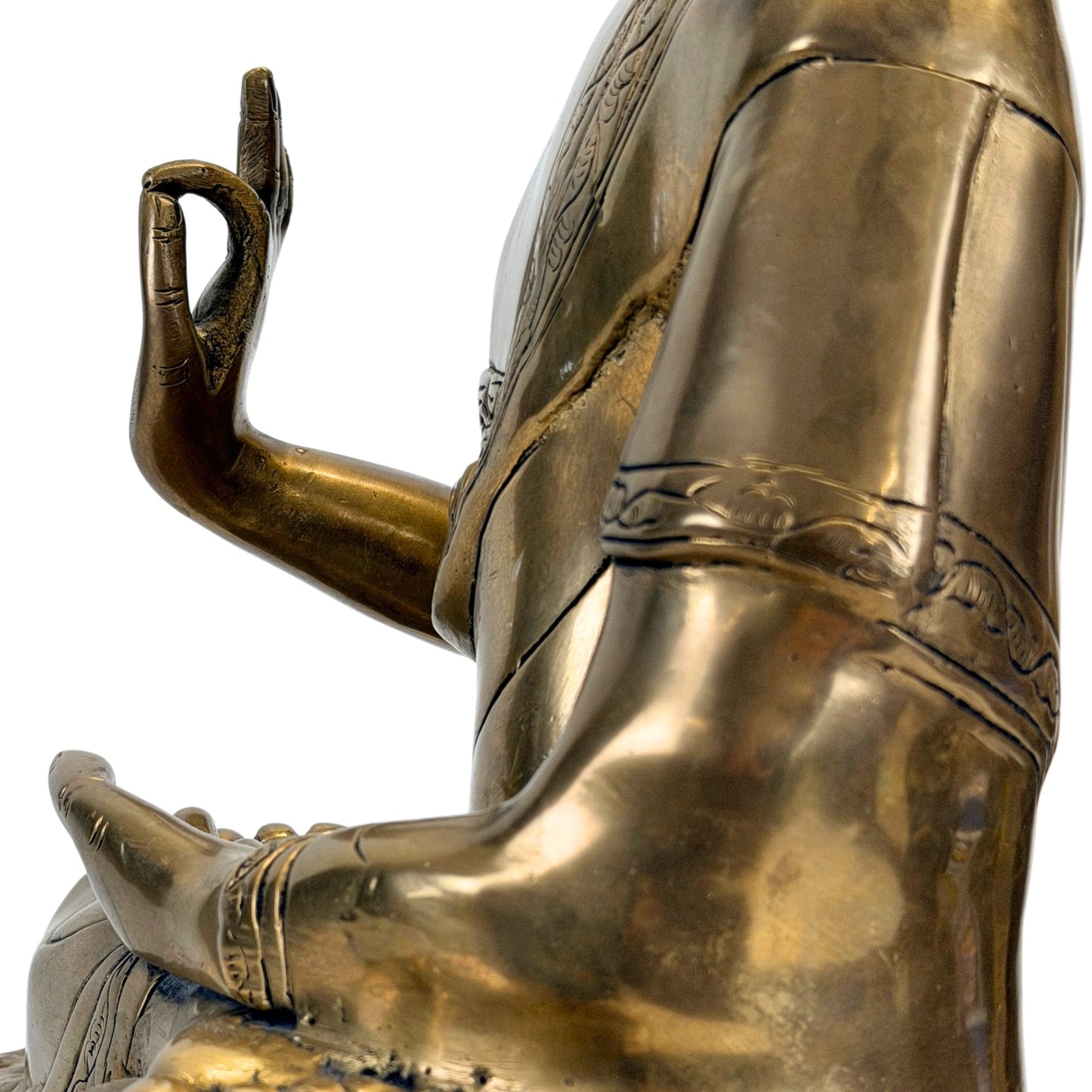 Raised hand and decorated robe edge of the Tibetan Shakyamuni Buddha