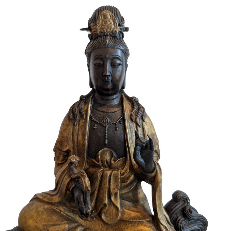 Detail of Guanyin's face, raised hand and partially gilded robes