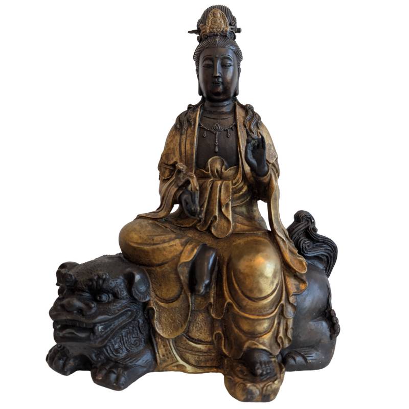 Front view of the vintage Chinese bronze Guanyin seated on a guardian lion