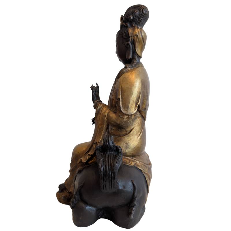 Left profile of Guanyin seated on the guardian lion