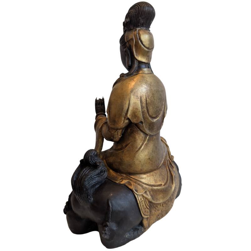 Rear-left view of the partially gilded Guanyin and dark bronze lion