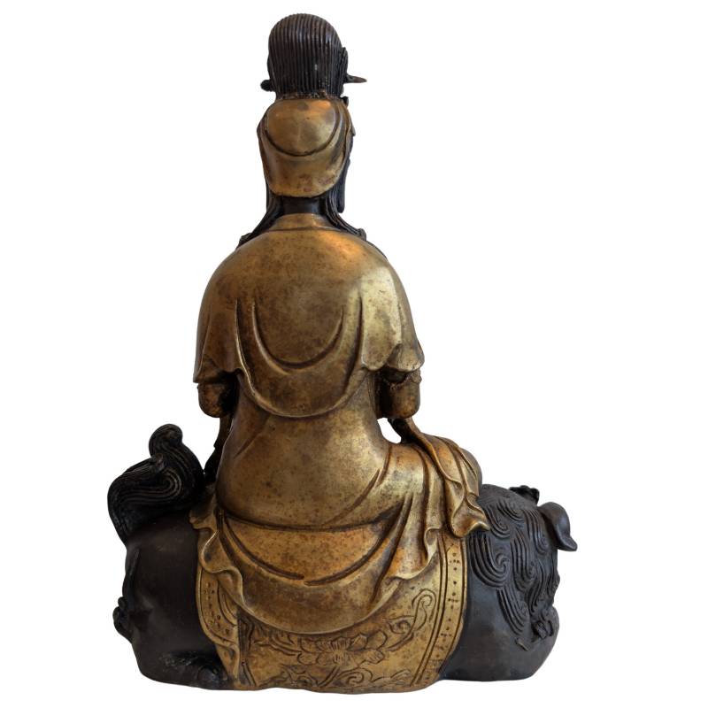Rear view of the Chinese bronze Guanyin seated across the guardian lion