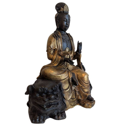 Right-front view of Guanyin with partially gilded robes and dark bronze guardian lion
