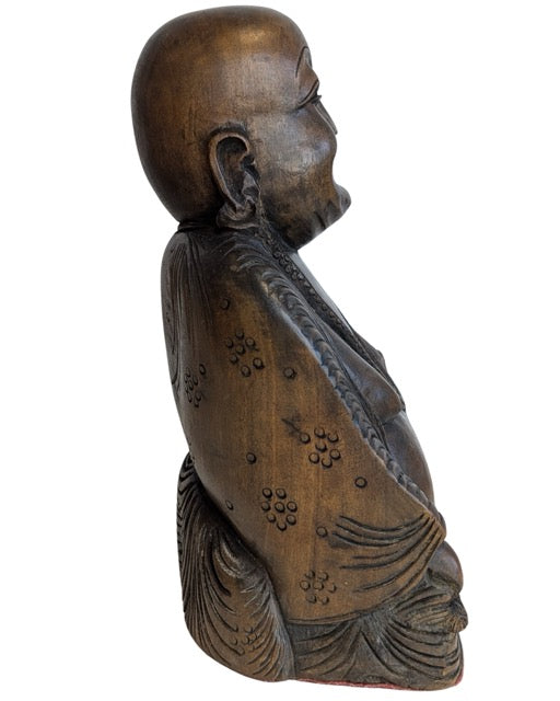 Detailed hands, robes and beads of the Laughing Buddha carving