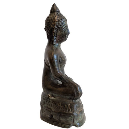 Right profile of the compact Thai bronze Buddha on its pedestal