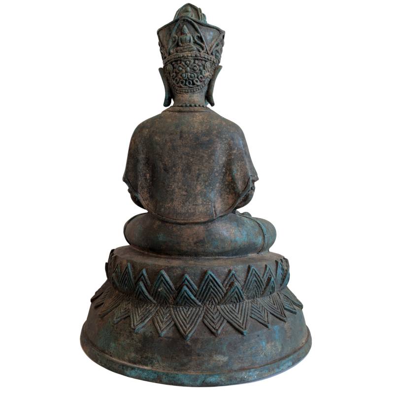 Rear view of the Thai crowned Buddha seated on the broad pedestal