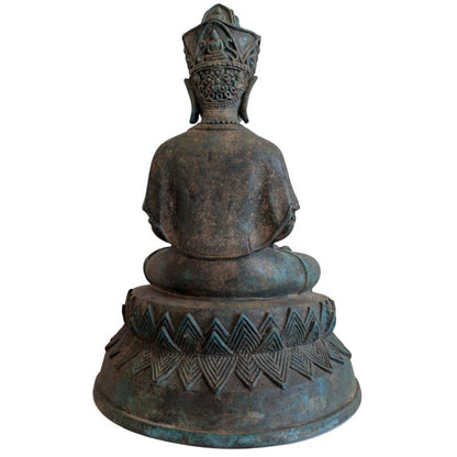 Rear view of the Thai crowned Buddha seated on the broad pedestal